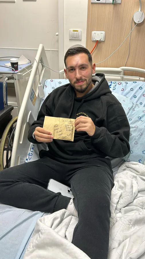 A soldier recovering in a hospital bed, sitting up and reading a handwritten letter