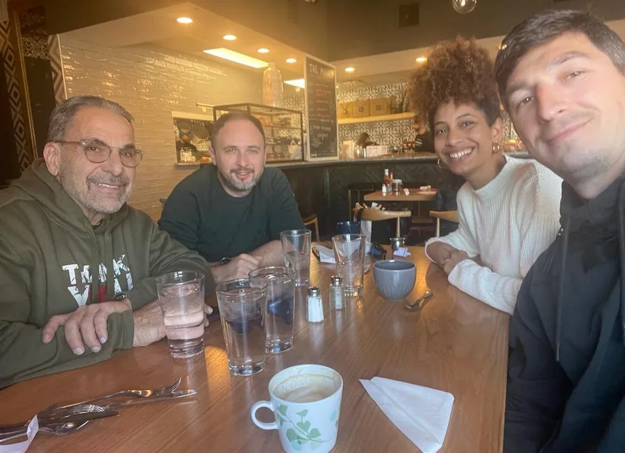 Ivan Sacks with three others around a café table during a trip to Israel